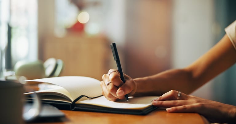 Woman journaling at sunrise