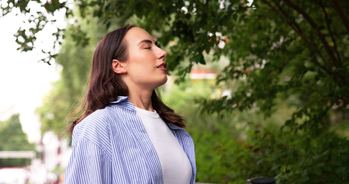 Woman Meditating In Nature, Embracing The Fresh Clean Air Around Her.