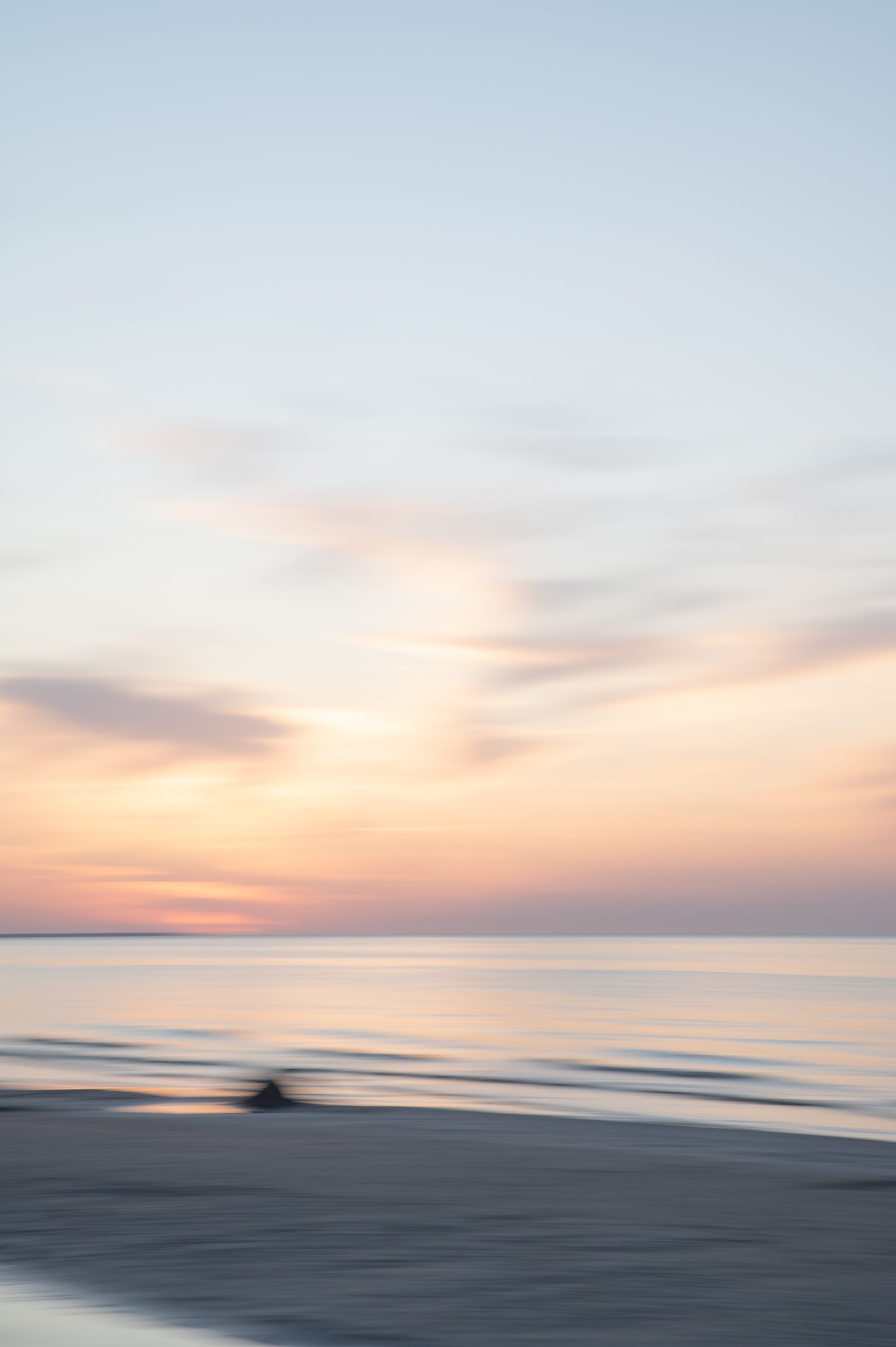 Tranquil ocean seascape at sunset with soft blurred horizon