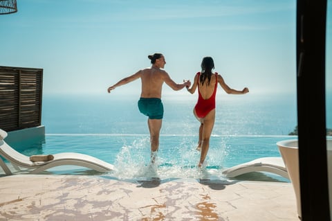 A couple joyfully enjoying the ocean in Los Cabos