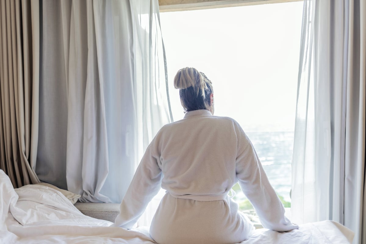 Woman in calm morning light — PRESENCIA™ embodied wellness methodology