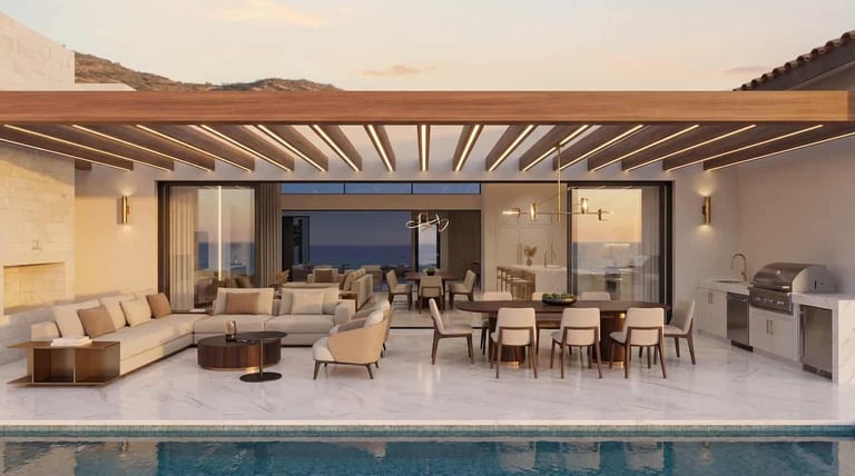 Modern luxury home with open-plan living area, sectional sofa, dining table, and swimming pool overlooking desert landscape at sunset